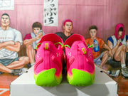 Rear view of pink Under Armour sneakers with neon green heel sections.