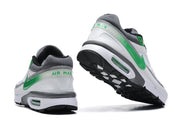 Rear and angled outsole views showing green heel accents and black tread.