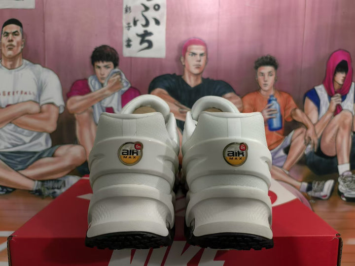 Rear view of white Nike Air Max sneakers showing Air Max heel branding, black outsole sections, and a red shoebox.
