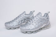 Pair of silver-gray Nike TN-4 sneakers shown at a three-quarter angle