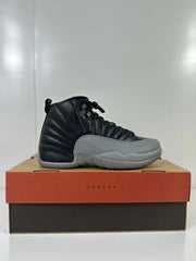Side profile of a black high-top sneaker with grey panels and sole