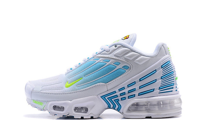 White Nike sneaker with light blue side panels, neon green Swoosh, geometric side detailing, and visible sole cushioning.