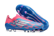 Pink and blue F50 soccer cleat with its studded outsole visible.