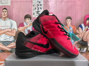 Pair of red and black Nike basketball shoes shown at an angle