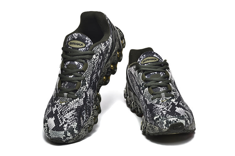Pair of patterned black, white, and gray Nike Air Max sneakers viewed from the front.