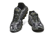 Pair of patterned black, white, and gray Nike Air Max sneakers viewed from the front.
