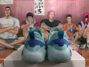 Rear view of light blue basketball sneakers showing darker blue heel panels, pull tabs, and visible XII markings.