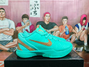 Side profile of a turquoise Nike basketball shoe with gold-tone detailing