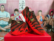 Angled side view showing the textured black and red upper, Nike Swoosh and red outsole.
