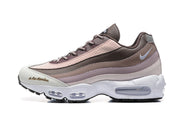 Side view of brown, pink, and light neutral Nike sneakers with visible Air units.