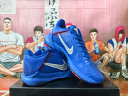 Angled view of blue Nike Kobe shoes showing white side swooshes and red accent stitching.