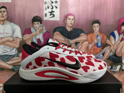 Side view of a white and red Nike sneaker showing the black Swoosh, patterned upper, and red outsole accent.