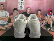 Rear view of a white pair of Nike basketball sneakers showing padded collars, heel details, and black midsole sections.