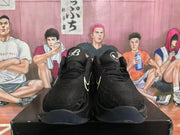 Front view of the black Nike basketball shoes with light-colored Swoosh accents.