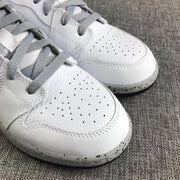 Close-up of the white perforated toe boxes, grey laces, stitching, and speckled midsole.