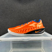 Side profile of an orange Nike GT basketball shoe with blue lining