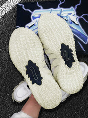 Close-up of the patterned off-white outsoles with black central traction sections.
