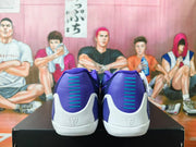Rear view of the Nike Kobe shoes showing purple heel panels and white soles.