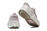 Rear and outsole views of Nike sneakers in pink, gray, and white