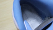 Close-up view of the blue padded collar and textured inner footbed.