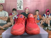 Front view of coral pink Nike basketball sneakers with matching laces and contrasting outsole details.