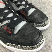 Close-up of black toe panels, grey perforated lace panels, red eyelets, and elephant-print trim