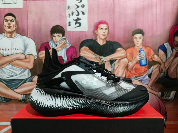 Side view of black and white Under Armour basketball sneakers displayed on a box.