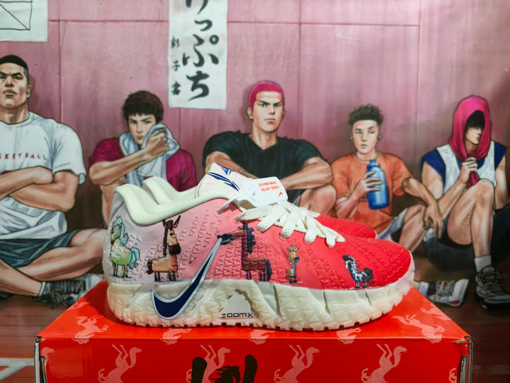 Side view of pink and red Nike basketball sneakers with illustrated panels, white laces, navy swoosh branding and a sculpted light-colored outsole.
