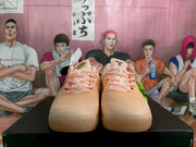 Front view of the pink Nike basketball sneakers showing the lacing and rounded toe areas.