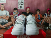 Front view of white Nike high-top sneakers with perforated toe panels, padded collars, and fastening straps on a Nike shoebox.