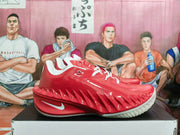 Side view of a red Nike GT basketball shoe with a white Swoosh and sculpted side panels.