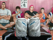Rear view of gray basketball shoes with blue heel lettering and patterned soles