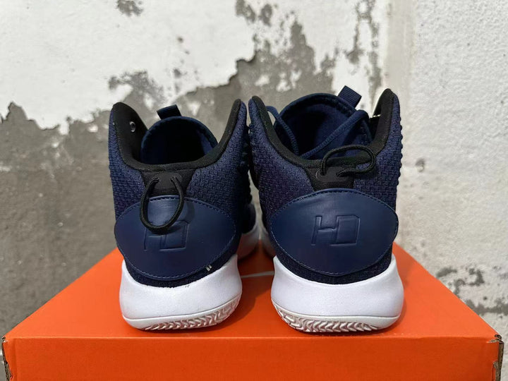 Rear view of navy Nike basketball shoes showing heel details and white outsoles