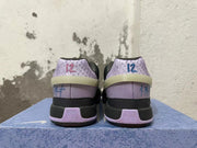 Rear view of black and lavender Nike basketball shoes with patterned heel panels