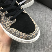 Close-up of the black perforated toe box, black laces, and leopard-print eyestay and toe overlay.