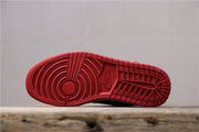 Red outsole with circular and block-pattern tread.