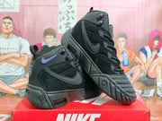 Angled view of black Nike high-top sneakers showing the side panels, raised outsole details, and purple accents.