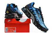Pair of blue patterned Nike Air Max Plus VII sneakers displayed with a red Nike shoe box; box label shows sample sizes.