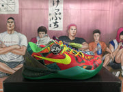 Side profile of a colorful Nike basketball shoe with a bright green swoosh and green sole.