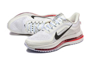 Pair of white Nike Pegasus Premium shoes with black Swoosh details and red midsole cushioning.