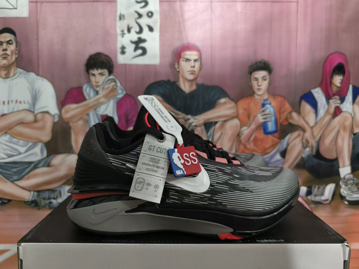 Nike GT Cut basketball shoe in black, gray, and red shown from the side