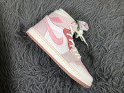 Side profile of one pink and white mid-top sneaker.