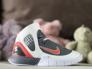 Side profile showing the gray upper, white overlays, red logo detail, and padded high-top collar.