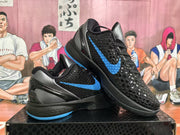 Angled view of the pair showing the textured black uppers, blue swoosh accents, metallic gray panels, and blue outsole details.