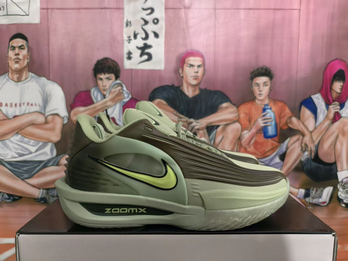 Side view of olive green Nike sneakers showing the lime Swoosh, layered upper and ZoomX midsole marking.
