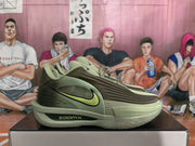 Side view of olive green Nike sneakers showing the lime Swoosh, layered upper and ZoomX midsole marking.
