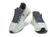 Pair of white and grey On running shoes shown from front and overhead angles.