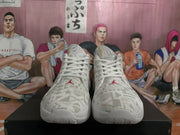 Front-facing view of the pair showing patterned tongues, white laces, and red Jumpman logos.