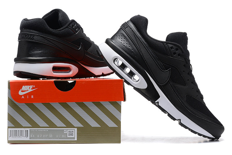 Black Nike Air Max sneakers shown with a branded shoe box; the box label appears to show a sample size.