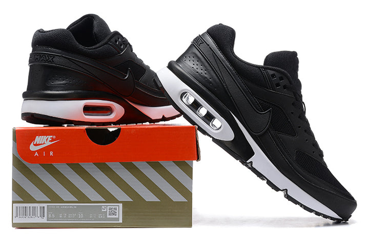 Black Nike Air Max sneakers shown with a branded shoe box; the box label appears to show a sample size.